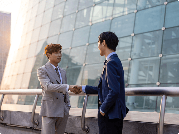 Businessmen shaking hands outdoors